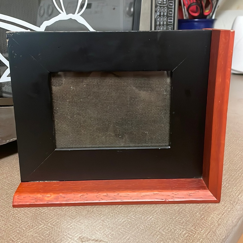 Wood self standing picture frame. Cherry colored wood, in very good condition.